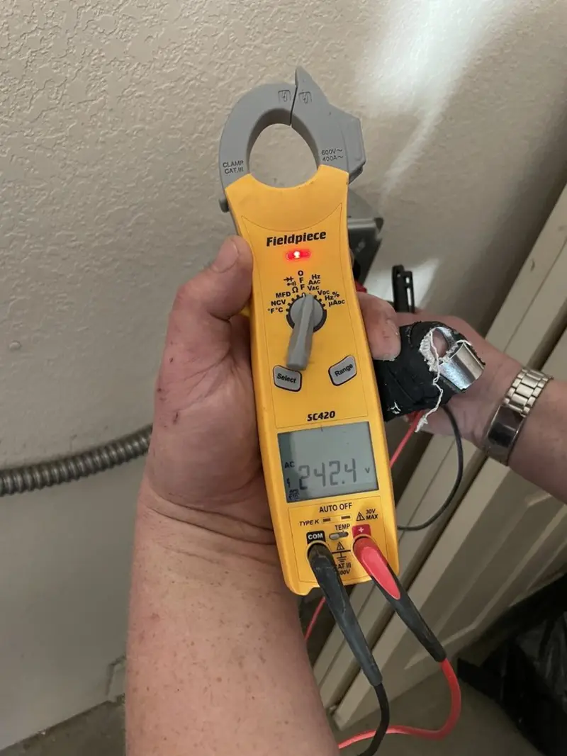 Voltage testing with clamp meter during Whole House Surge Protector in Pensacola Station